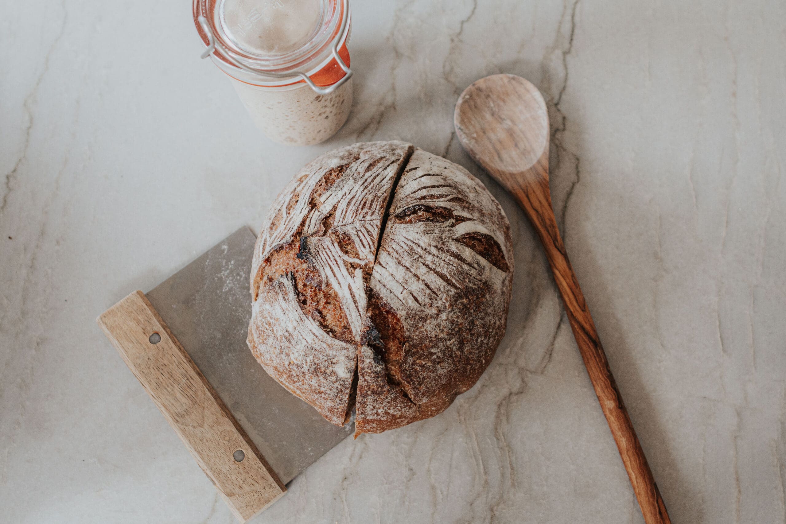 Sourdough bread and sourdough starter with bench knife