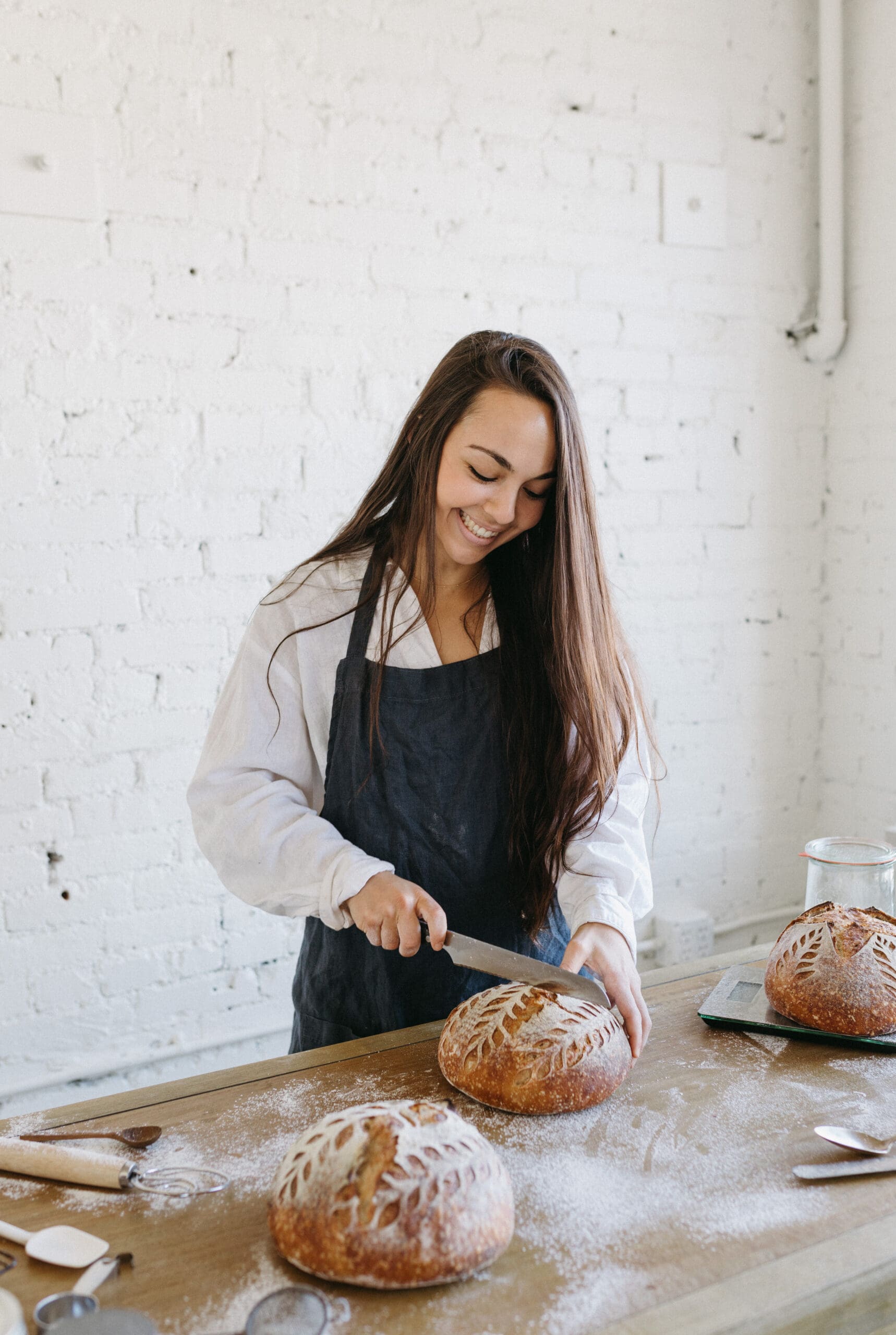 Girl cutting sourdough bread