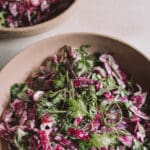 Purple coleslaw in beige ceramic dish