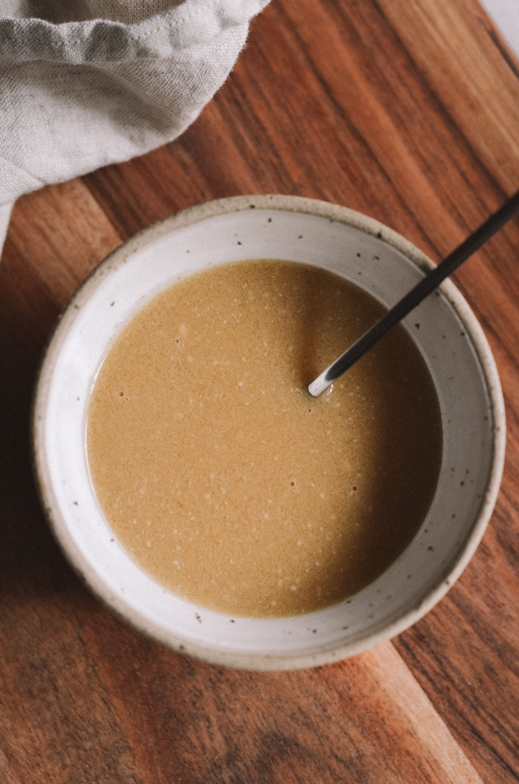 Gluten-free ginger miso dressing in ceramic bowl