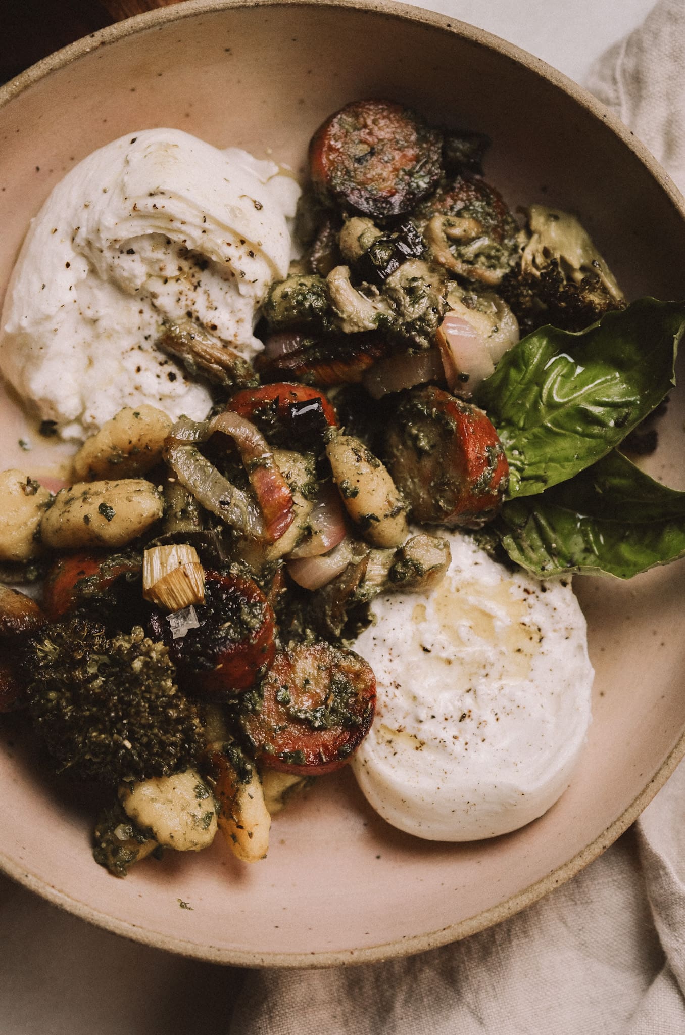 Gluten-free pesto gnocchi in ceramic dish